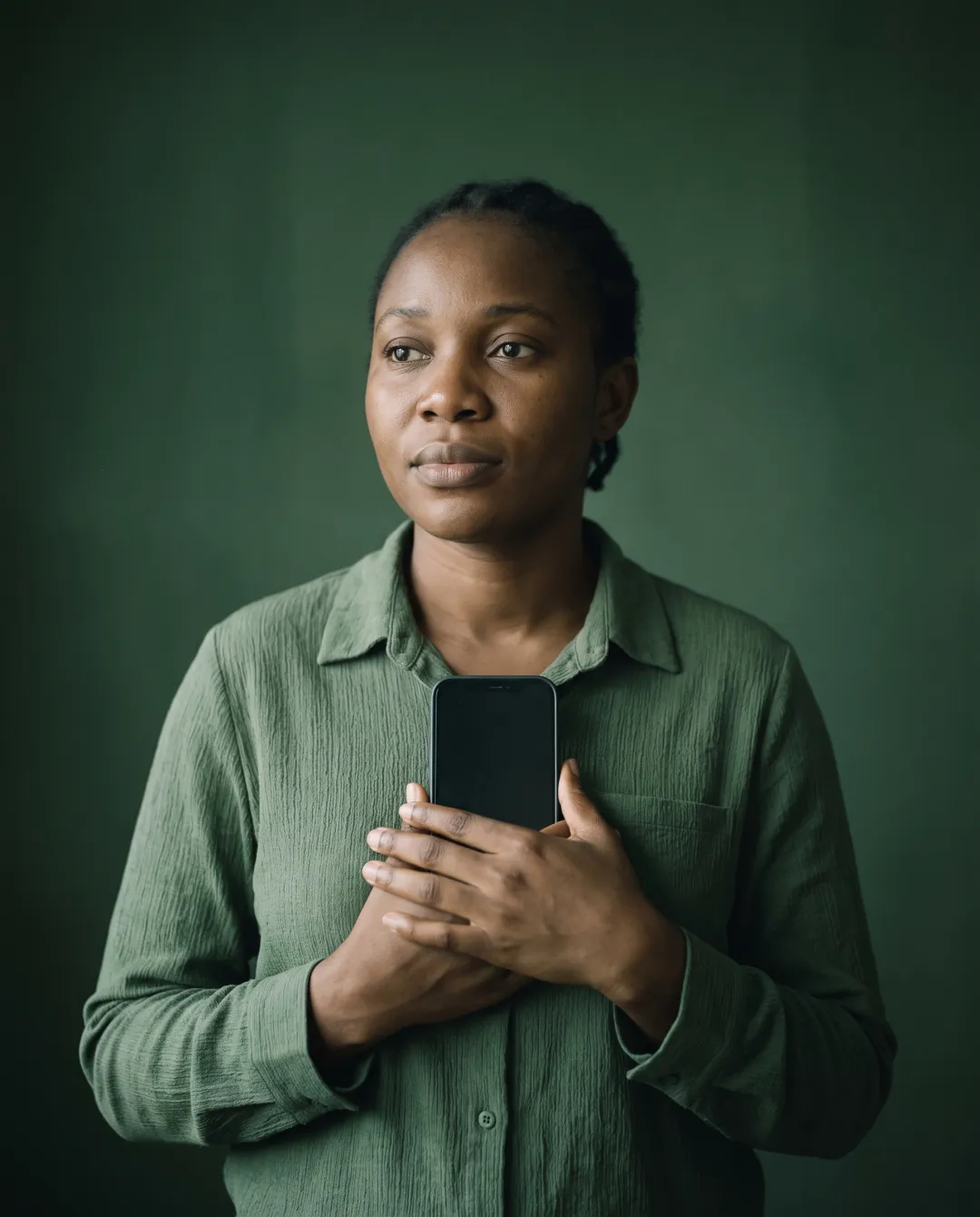 A woman holding her phone close, in control of her record