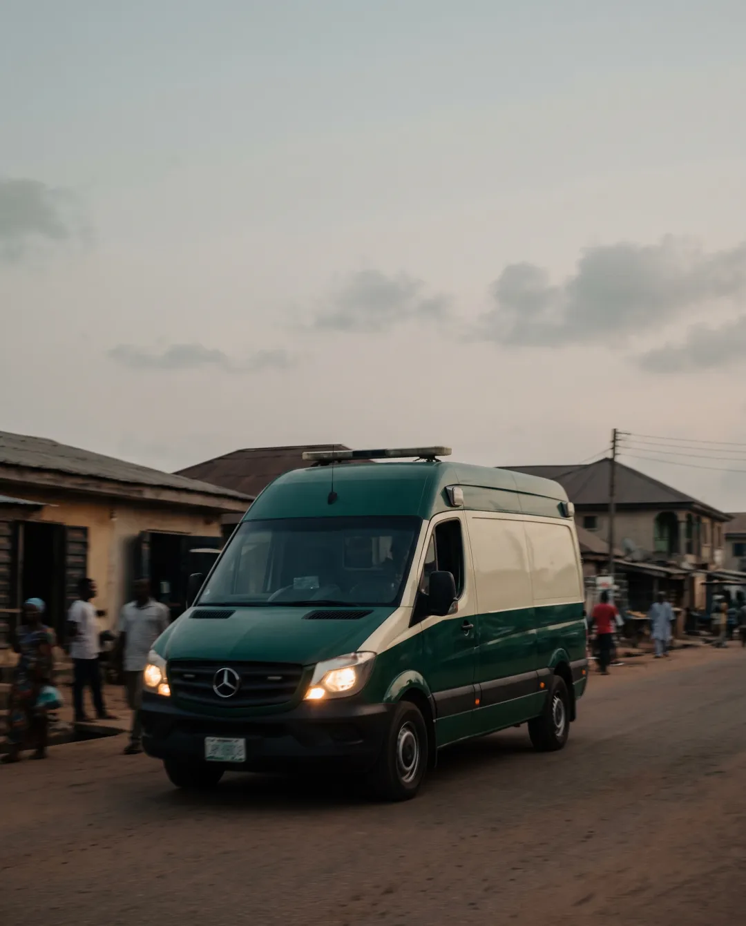A PHB ambulance on a Lagos street at dusk